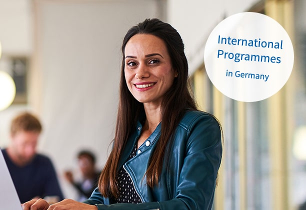 Smiling woman. Top right a banner showing "International Programmes in Germany".